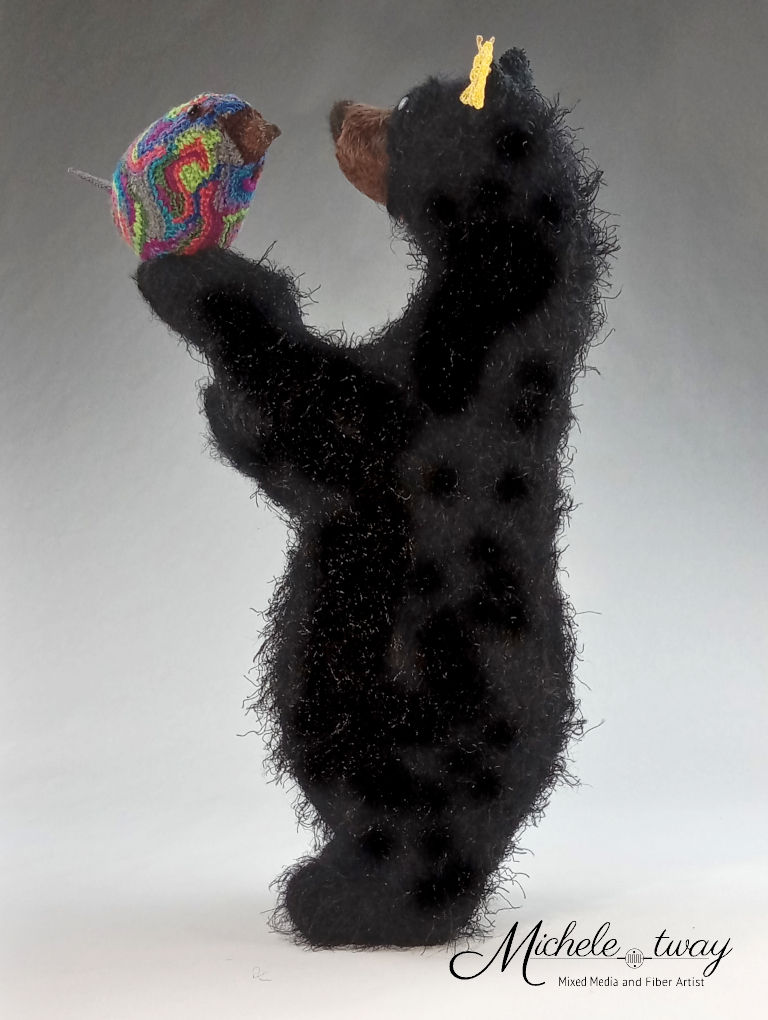 Bella, a mixed media bear sculpture shown in profile.