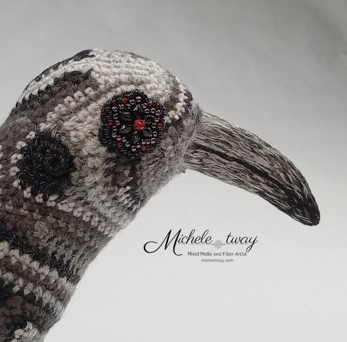 Close up of beaded eye and embroidered beak - Echo by Michele Tway