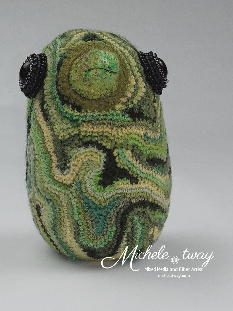 Forest, a free-form crochet, embroidered and bead embroidered bird sculpture.